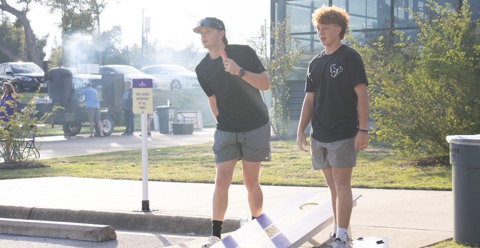 Students enjoying a game of cornhole.